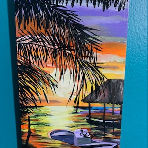 May include: A painting of a sunset over a body of water with a small boat docked at a pier. The scene is framed by palm tree leaves in the foreground. The sky is a vibrant mix of orange, yellow, and purple.