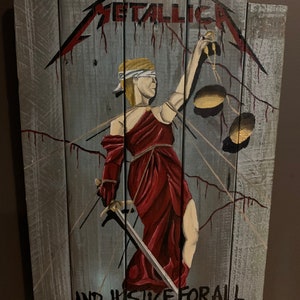 May include: A wooden sign with a painting of the Lady Justice holding a sword and scales. The sign is painted in shades of gray, red, and gold. The text "...AND JUSTICE FOR ALL" is written at the bottom of the sign. The text "METALLICA" is written at the top of the sign.