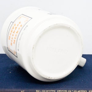 May include: White ceramic mug with a black and orange design. The mug has the text "Happy Birthday" and "To My Awesome Mom" on it.