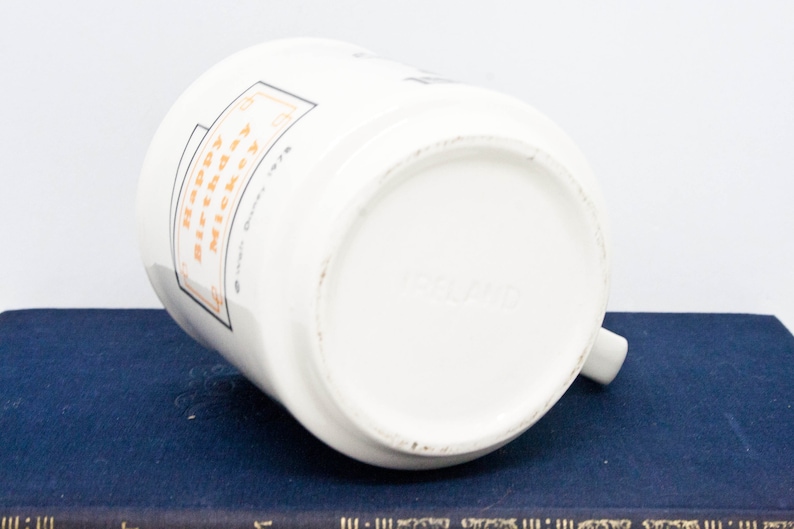 May include: White ceramic mug with a black and orange design. The mug has the text "Happy Birthday" and "To My Awesome Mom" on it.