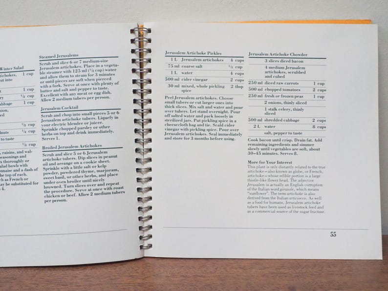 May include: Open cookbook with spiral binding, featuring recipes for Jerusalem artichokes. The pages display text with ingredient lists and instructions for various dishes, including pickles and chowder. The page number 55 is visible.