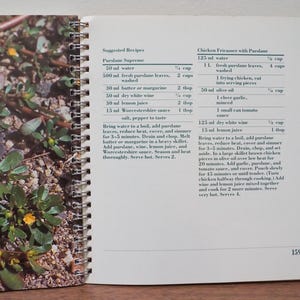 May include: Open cookbook page with recipes for Purslane Supreme and Chicken Fricassee with purslane. The left page shows purslane plants with small yellow flowers. The right page has the recipe instructions.