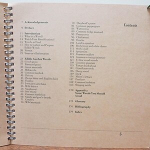 May include: Open book with a spiral binding, displaying the contents page. The text lists various edible weeds, including common dandelion and wild mustard. The page has a light brown color.