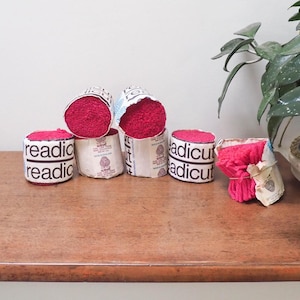 May include: Six spools of red yarn with the label "Readicut" on the front. The yarn is wrapped around cardboard spools.