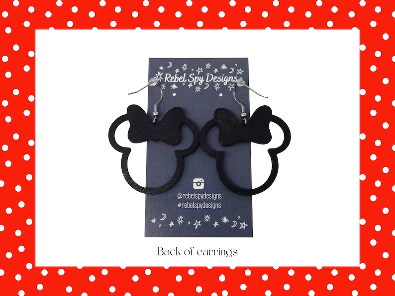 May include: Black Minnie Mouse silhouette earrings with a bow detail. The earrings are displayed on a dark blue card with the text "Rebel Spy Designs" and social media handles. The background is a red border with white polka dots.