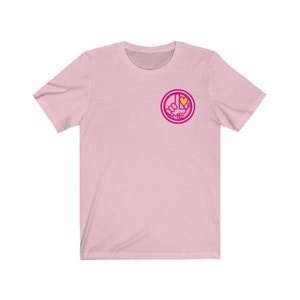 May include: Pink short-sleeved t-shirt with a pink and yellow graphic of a hand giving a thumbs up with a heart in the middle and the text "I LOVE ME" around it.