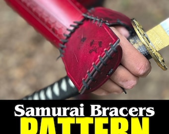 May include: Red leather samurai bracers with black stitching and a pattern. The bracers are worn on a person's arm and hand, holding a katana sword.