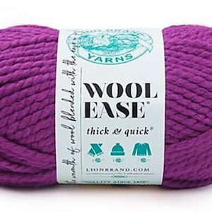 May include: A skein of thick, purple yarn labeled "Wool-Ease Thick & Quick" by Lion Brand Yarns. The yarn is a vibrant shade of purple, and the label includes icons of a hat, sweater, and scarf.