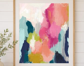 Puede incluir: Un cuadro abstracto rectangular enmarcado con salpicaduras vibrantes de rosa, coral, verde lima, azul cerceta y azul marino. La obra cuelga sobre una mesa consola de madera clara con tres cajones, dos cestas tejidas, un jarrón y libros apilados.