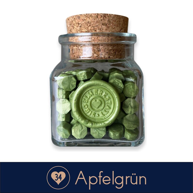 May include: A glass jar filled with green wax sealing beads. The jar has a cork lid and a label that says "Siegel Werkstatt".