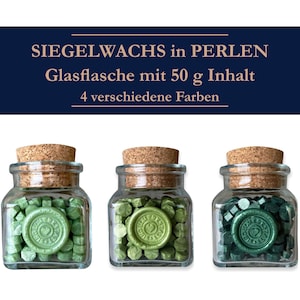 May include: Three glass jars with cork lids filled with green and dark green wax beads. Each jar contains 50 grams of wax beads. The jars are labeled "Siegelwachs in Perlen" and "Glasflasche mit 50 g Inhalt".