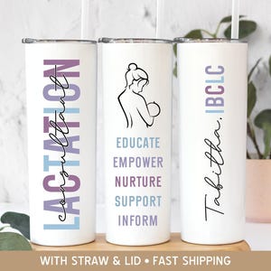 May include: Three white stainless steel tumblers with different designs. The first tumbler has the text "Lactation consultant" in purple and blue lettering. The second tumbler has a line drawing of a woman breastfeeding a baby with the text "Educate, Empower, Nurture, Support, Inform" in purple and blue lettering. The third tumbler has the text "Tabitha. IBCLC" in purple and blue lettering.