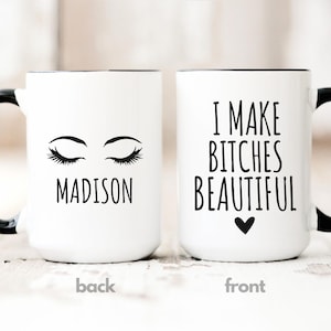 May include: White ceramic mug with a black handle and rim. The front of the mug has the text "I MAKE BITCHES BEAUTIFUL" with a heart symbol. The back of the mug has the name "MADISON" and closed eyelashes.