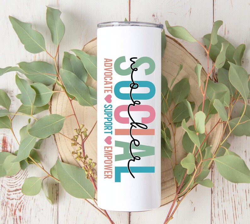 May include: White tumbler with the words "SOCIAL WORKER" in colorful letters. The words "ADVOCATE", "SUPPORT", and "EMPOWER" are written vertically on the side of the tumbler.
