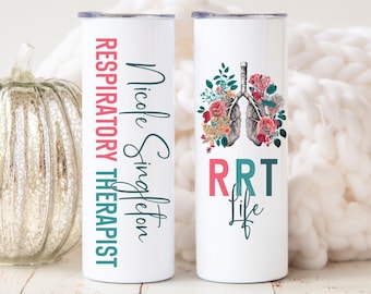 May include: Two white stainless steel tumblers with a floral design. One tumbler has the text "Nicole Singleton Respiratory Therapist" and the other has a floral design with lungs and the text "RRT Life".