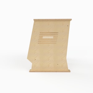 May include: A light-colored wooden stand with a trapezoidal side profile, featuring a flat top and base. The side panel displays a series of horizontal, parallel cut-out slats and two small circular holes positioned near the bottom corners.
