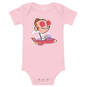 May include: Pink babygrow featuring a cartoon character wearing red sunglasses and a white shirt, flying a red rocket ship with a purple interior.