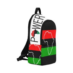 May include: Black backpack with green, red, and black stripes and a white panel with the word "POWER" and an outline of the continent of Africa.