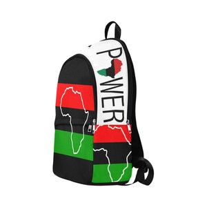 May include: Black, red, green, and white backpack with an outline of the continent of Africa and the word "POWER" printed on the side.