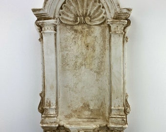 May include: A white, ornate, decorative wall shelf with a scalloped design and a distressed finish.