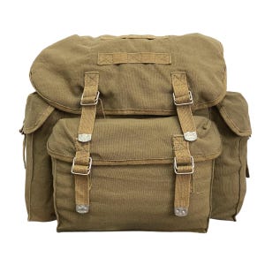 May include: An olive drab canvas rucksack featuring a large main compartment with a fold-over flap, two side pockets, and a front pocket. The bag includes adjustable webbing straps with metal buckles and a top carry handle for secure closure.