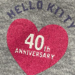 May include: Grey sweatshirt with a red heart graphic that says "40th Anniversary" and "Hello Kitty" in blue lettering.