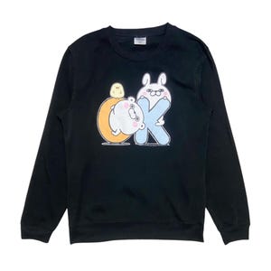 May include: Black long-sleeved sweatshirt with a graphic print of a white bear, a yellow chick, and a pink bunny holding a blue letter K. The graphic says "OK" with the K being the bunny.