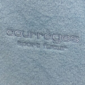 May include: A light blue fleece jacket with the embroidered text "Courr&egrave;ges sport futur" in white.