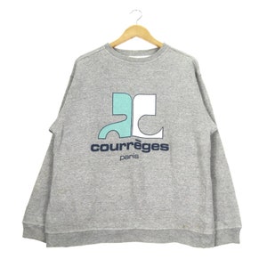 May include: Gray sweatshirt with a blue and white logo that says "Courr&egrave;ges Paris".