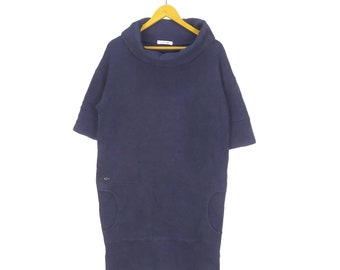 May include: A navy blue, short-sleeved, turtleneck dress with a loose fit and two pockets. The dress is made of a soft, comfortable fabric.