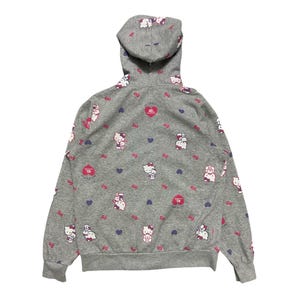 May include: A grey hooded sweatshirt with a Hello Kitty print. The sweatshirt features a repeating pattern of Hello Kitty characters, hearts, and bows. The text "Hello Kitty 40th Anniversary" is printed on the front of the sweatshirt.