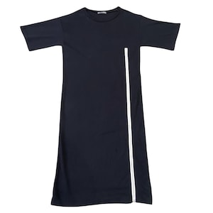May include: A black midi dress with short sleeves and a white zipper detail running vertically down the front. The dress has a crew neck and a simple, minimalist design, suitable for casual wear.