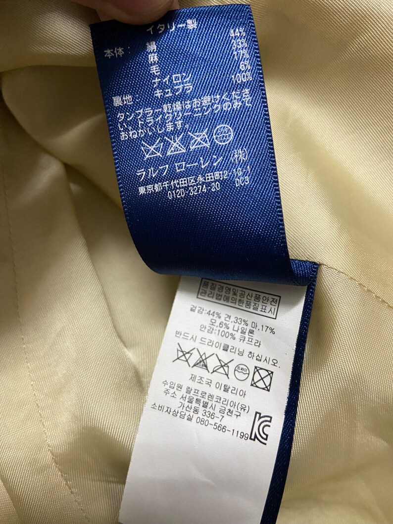 May include: A blue and white care label with washing instructions in both English and Korean. The label includes the text "Ralph Lauren" and "Made in Italy".