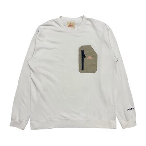 May include: White long-sleeve sweatshirt with a beige zippered pocket on the left side. The pocket has a small pink triangle logo with the word "KELTY" printed on it. The word "KELTY" is also printed on the right sleeve.