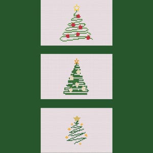May include: Three Christmas tree designs on a light pink background. The trees are made with green cross-stitch and decorated with red, white, and yellow accents. Each tree has a gold star on top. The background is a dark green.