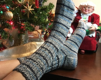 May include: A pair of blue and white striped socks with a fuzzy texture. The socks are worn on a person's feet, with one sock pulled up to the knee.