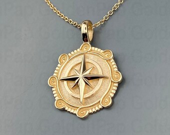 May include: A gold necklace with a compass pendant. The pendant is round and features a detailed compass rose design.