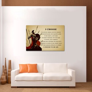 May include: A motivational quote about making choices, "I CHOOSE to live by choice, not by chance... I CHOOSE to be me."  The quote is printed on a canvas with a warrior holding a spear and shield in front of a red and brown background.