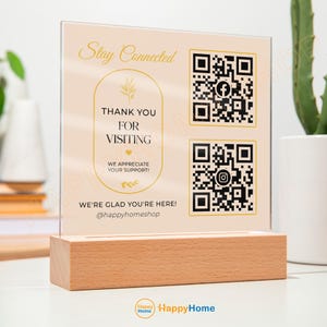 Könnte beinhalten: Ein rechteckiges Acrylschild mit hellbeigem Hintergrund und goldener Schrift, das die Worte Stay Connected, Thank You For Visiting und We Appreciate Your Support zeigt. Es enthält zwei QR-Codes mit Facebook- und Instagram-Symbolen.
