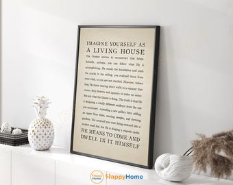 May include: A framed print with the text "IMAGINE YOURSELF AS A LIVING HOUSE" in black font. The print is in a black frame and is displayed on a white surface. Decorative items, including a pineapple-shaped ornament, are also visible.