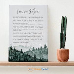 May include: A watercolor-style print with a forest background and a quote about love in action from Romans 12:9-21. The quote reads: "Love must be sincere. Hate what is evil; cling to what is good. Be devoted to one another in love. Honor one another above yourselves. Never be lacking in zeal, but keep your spiritual fervor, serving the Lord. Be joyful in hope, patient in affliction, faithful in prayer. Share with the Lord's people who are in need. Practice hospitality. Bless those who persecute you; bless and do not curse. Rejoice with those who rejoice; mourn with those who mourn. Live in harmony with one another. Do not be proud, but be willing to associate with people of low position. Do not be conceited. Do not repay anyone evil for evil. Be careful to do what is right in the eyes of everyone. If it is possible, as far as it depends on you, live at peace with everyone. Do not take revenge, my dear friends, but leave room for God's wrath, for it is written: "It is mine to avenge, I will repay, says the Lord. On the contrary: "If your enemy is hungry, feed him; if he is thirsty, give him something to drink. In doing this, you will heap burning coals on his head." Do not be overcome by evil, but overcome evil with good. - Romans 12:9-21"