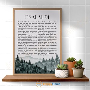 May include: A framed print of Psalm 91, featuring the text in a classic font. The bottom of the print displays a serene forest scene in shades of gray and green. The print is displayed on a wooden shelf with three potted succulents.