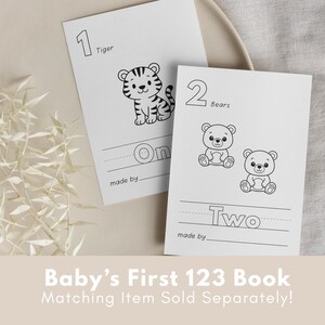 May include: Two black and white printable flashcards for a baby's first 123 book. The first card features a tiger with the number 1 and the word "One". The second card features two bears with the number 2 and the word "Two".