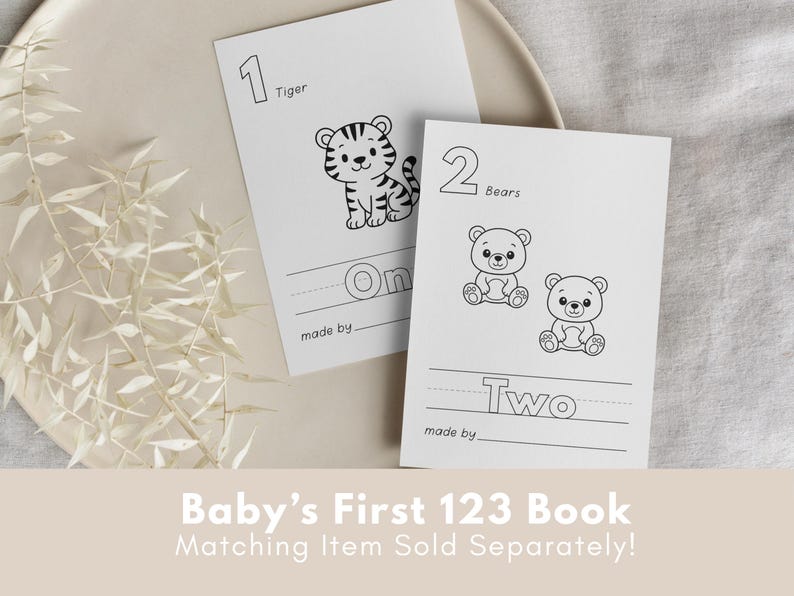 May include: Two black and white printable flashcards for a baby's first 123 book. The first card features a tiger with the number 1 and the word "One". The second card features two bears with the number 2 and the word "Two".