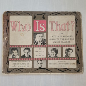 May include: Vintage book cover titled "Who Is That?" in pink and white, featuring portraits of classic movie stars. The cover includes text such as "The Late Late Viewers Guide to the Old Old Movie Players" and the names of the designers and publisher.