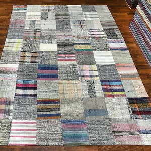 May include: A patchwork rug featuring a mix of colours and patterns, including stripes, checks, and plain fabrics. The rug is made from recycled materials and has a rustic, vintage appearance.