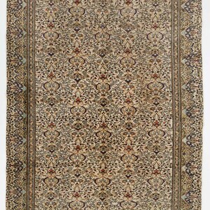 K&ouml;nnte beinhalten: Ein Vintage-Teppich mit cremefarbenem Hintergrund und komplizierten floralen Mustern in Braun-, Blau- und Rott&ouml;nen. Der Teppich hat einen Rand mit einem sich wiederholenden Muster.
