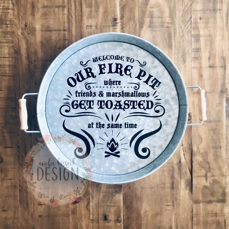 May include: A galvanized metal serving tray with handles. The tray has a black graphic that says "Welcome to Our Fire Pit... where friends & marshmallows get toasted at the same time".