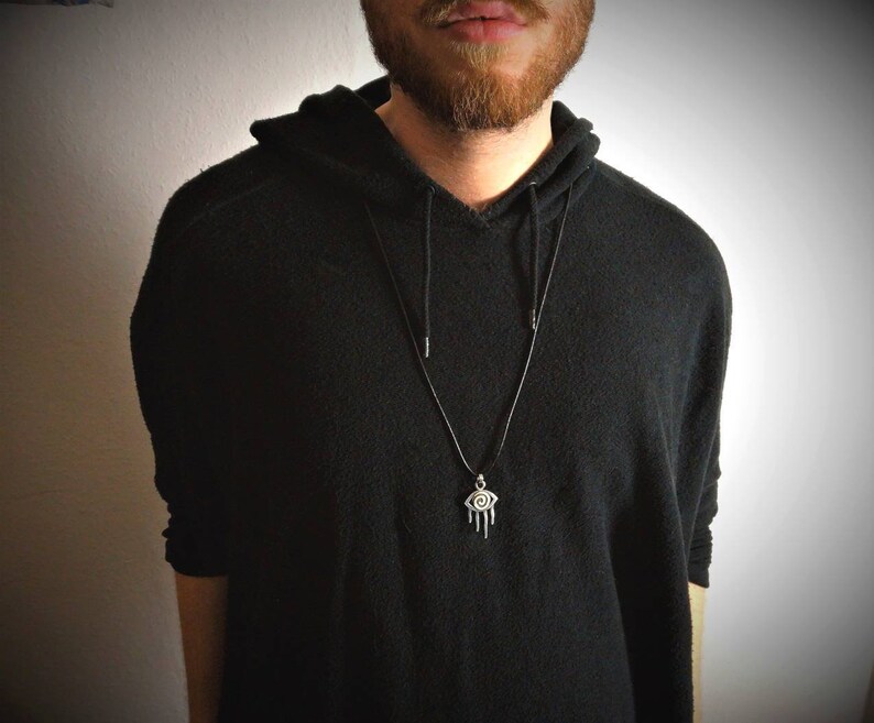 Oxidized silver pendant aztec style with gold eye