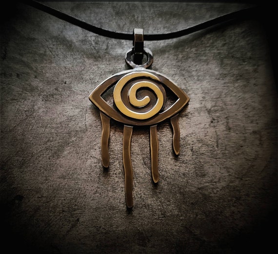 Oxidized silver pendant aztec style with gold eye